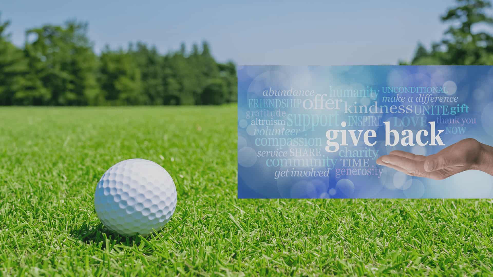 a golf ball on the grass with a business card in front of it