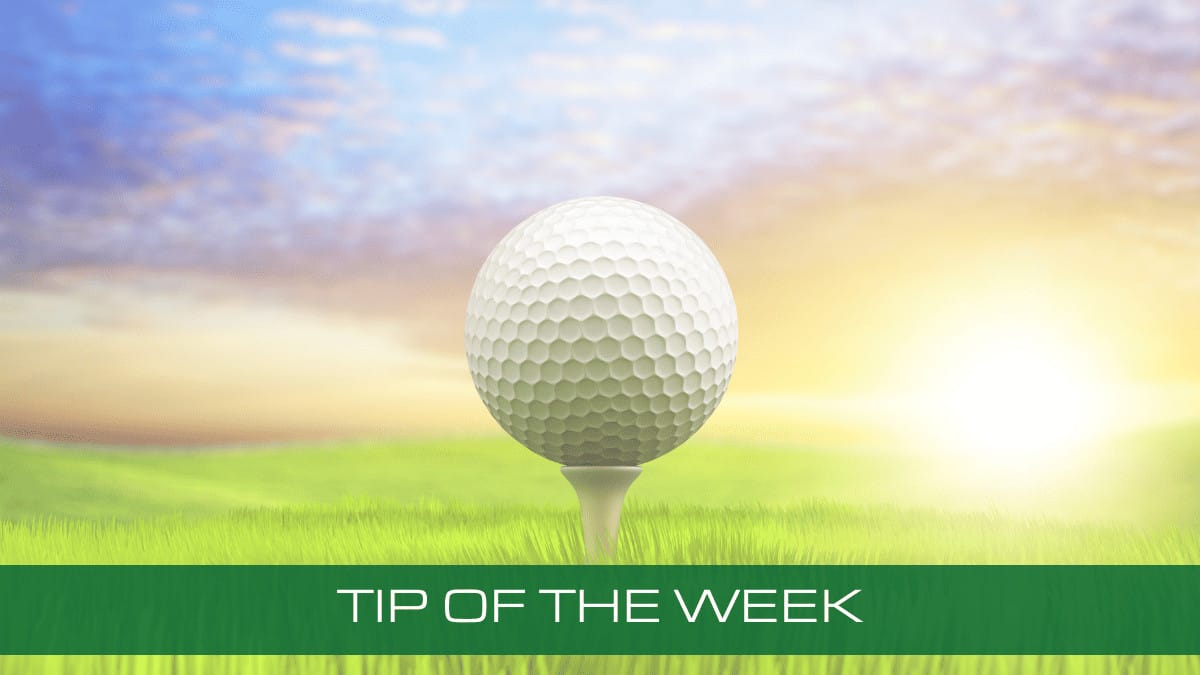 a golf ball sitting on top of a tee