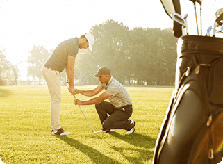 two men are playing golf in the grass