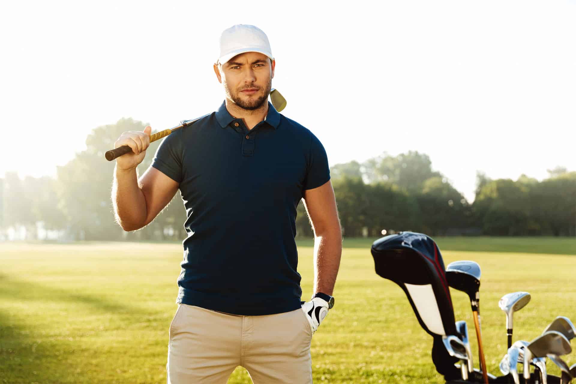 a man holding a golf club in his right hand