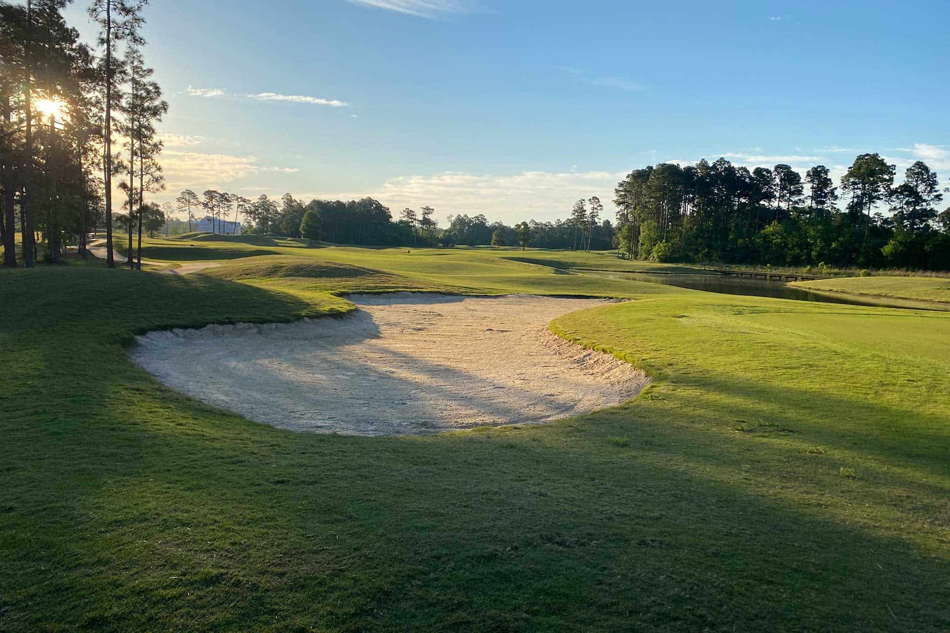 a golf course with a sand trap in the foreground