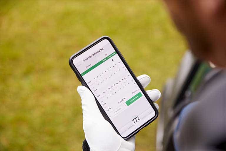 Person holding a smartphone displaying a calendar schedule application.