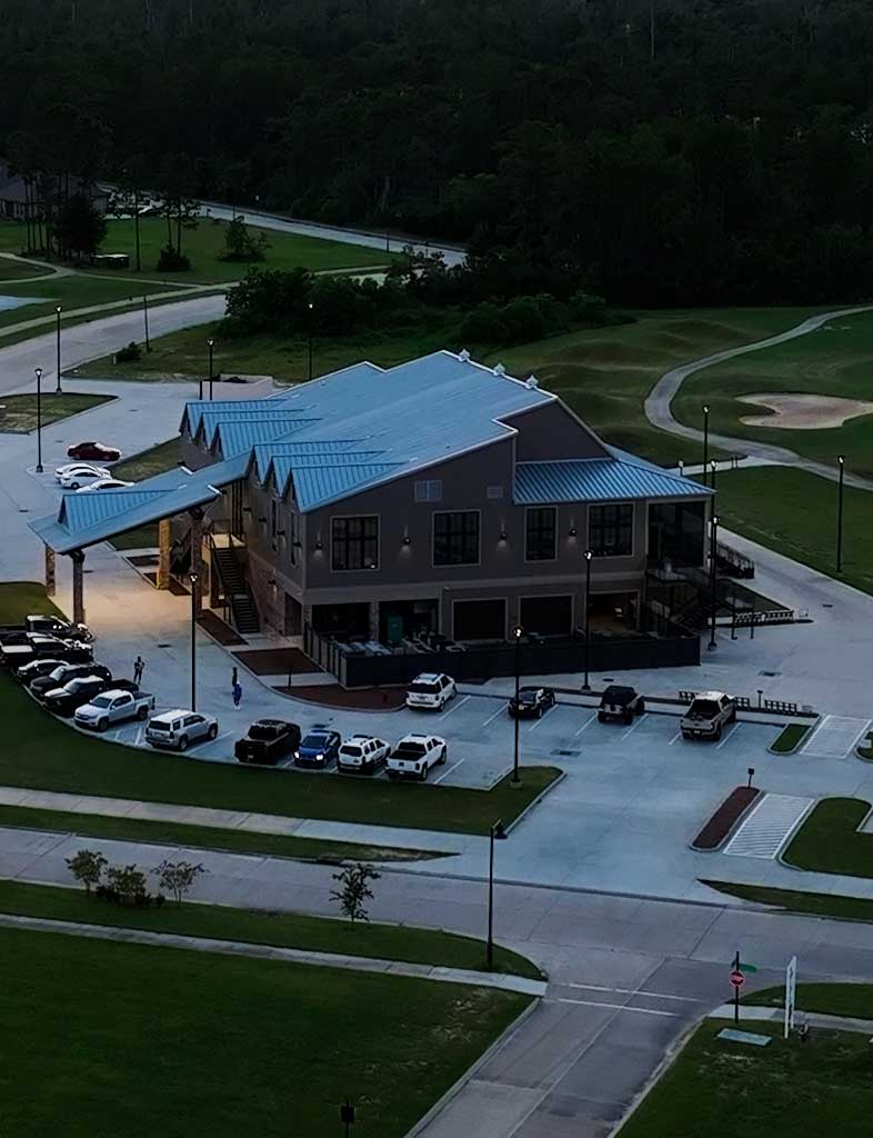 an aerial view of a parking lot with cars parked in it